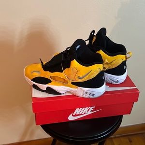 Kids Nikes. Size 7y. Barely worn. Black, yellow and white with grey Nike sign.